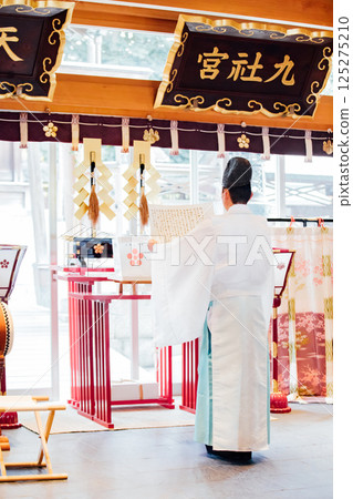 Praying at the shrine 125275210