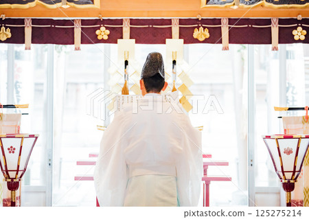Praying at the shrine 125275214