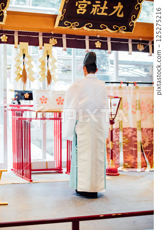 Praying at the shrine Praying at the shrine 125275216