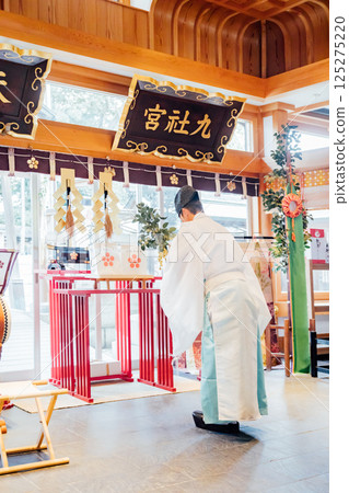 Praying at the shrine 125275220