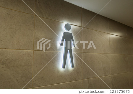 Minimalist Neon Male Restroom Symbol Highlighted on Stylish Wall Surface 125275675