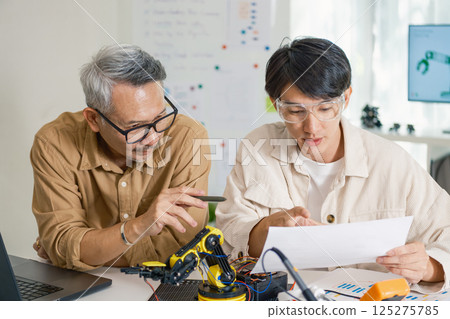 engineering robot technology with asian programmer innovation and research teamwork in coding development 125275785