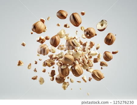 Hazelnut splash with cracked nuts and flying pieces isolated on white background with copy space 125276230