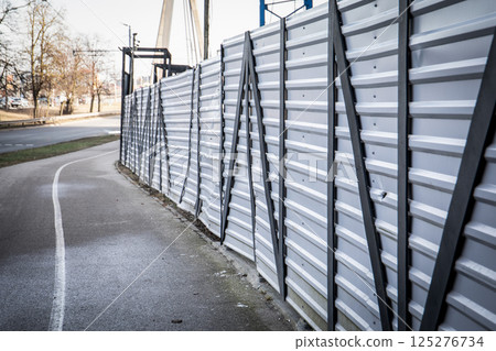 White Temporary Construction Fence Along Roadway White Temporary Construction Fence Along Roadway 125276734