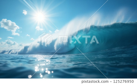 a beautiful ocean wave with splashes and the sun on a blue sky background, a heavenly seascape 125276950
