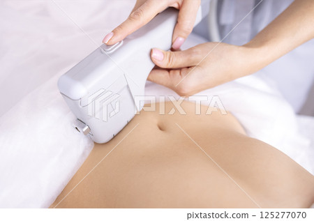 Portrait of relaxed young female client getting SMAS ultrasound face lifting massage Portrait of relaxed young female client getting SMAS ultrasound face lifting massage 125277070