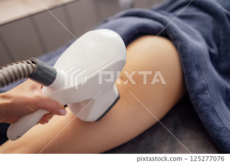 Close up of anti-cellulite massage of of the whole the device for vacuum roller massage Close up of anti-cellulite massage of of the whole the device for vacuum roller massage 125277076