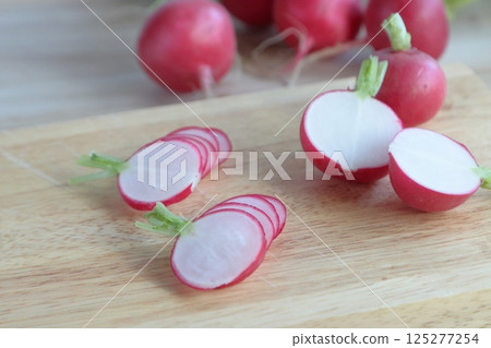 Radishes cut on a cutting board Radishes cut on a cutting board 125277254