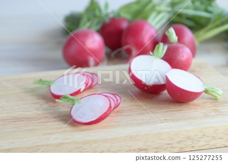 Radishes cut on a cutting board 125277255