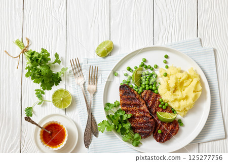 grilled beef cutlets with potato mash, green peas grilled beef cutlets with potato mash, green peas 125277756