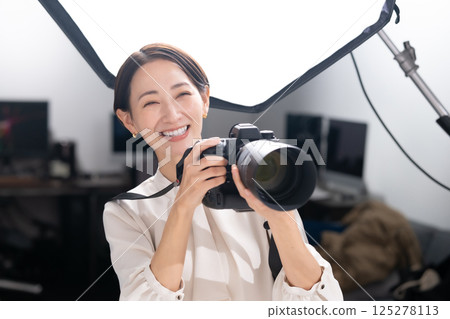 Female photographer shooting camera 125278113