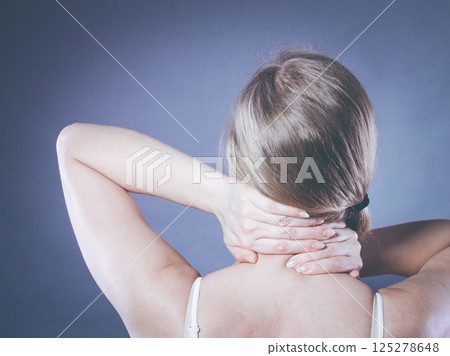 Woman suffering from neck pain 125278648