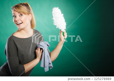 Cheerful lady with household items. 125278989