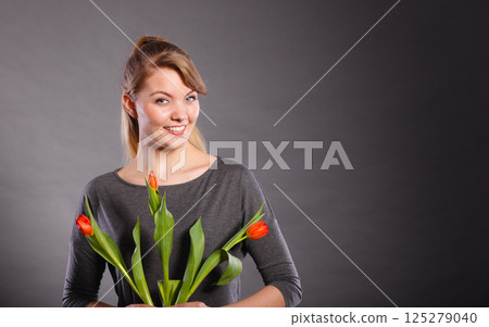Smiling female holding boquet. 125279040