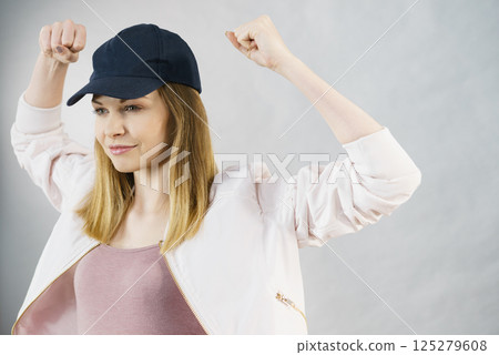 Young woman showing her arm muscles 125279608