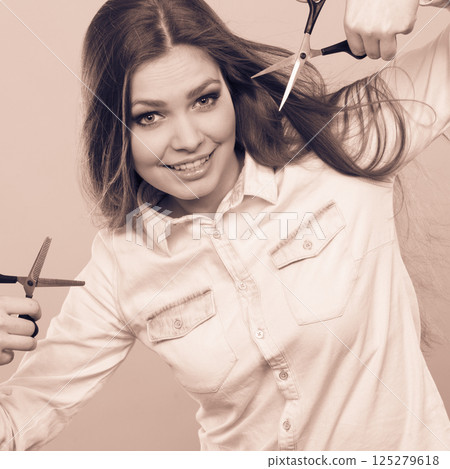 Passionate female hairdresser. 125279618