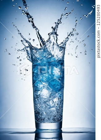 a glass filled with clean drinking water on a blue background, cooled with ice cubes 125280493