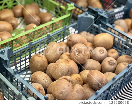 Ripe juicy selected kiwis are sold in plastic boxes by weight in an elite supermarket. Close-up Ripe juicy selected kiwis are sold in plastic boxes by weight in an elite supermarket. Close-up 125280628