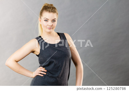 Happy woman wearing black tank top 125280786