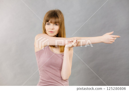 Woman working out at home stretching body 125280806