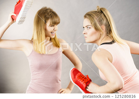 Women fighting with shoes 125280816