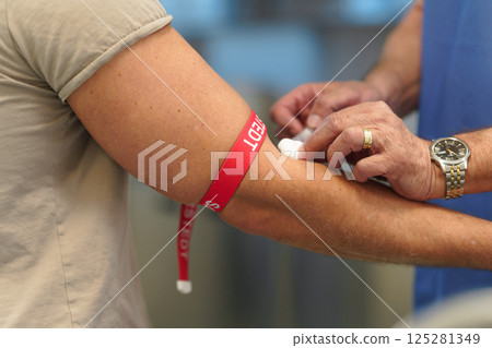 Close up of drawing blood from patient's arm. 125281349