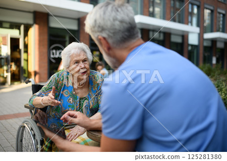 Doctor explaining medication to senior patient and answering her questions. Doctor explaining medication to senior patient and answering her questions. 125281380