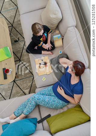 Top View of Mother and Daughter Enjoying a Fun Board Game on the Couch at Home Top View of Mother and Daughter Enjoying a Fun Board Game on the Couch at Home 125281508