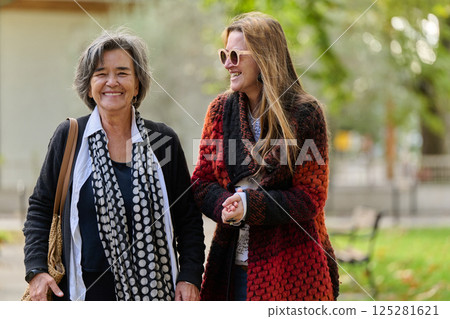 Autumn Walk: A Mother and Daughter Share Love and Support in Natures Embrace. 125281621
