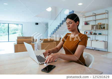 Woman sitting in living room using laptop looking at cam talk by video call with business friend relatives, head shot. Job interview answering questions 125281629