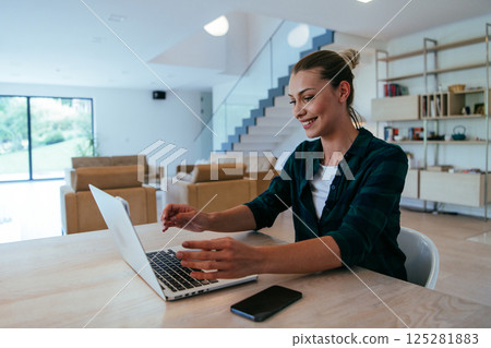 Woman sitting in living room using laptop looking at cam talk by video call with business friend relatives, head shot. Job interview answering questions 125281883