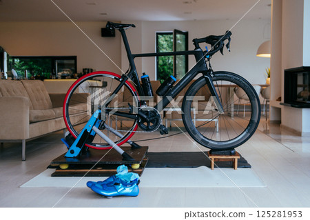 Photo of a triathlon bike in the living room ready for training at home due to the corona virus Photo of a triathlon bike in the living room ready for training at home due to the corona virus 125281953