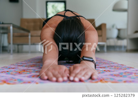 Young Beautiful Female Exercising, Stretching and Practising Yoga with Trainer via Video Call Conference in Bright Sunny House. Healthy Lifestyle, Wellbeing and Mindfulness Concept 125282379
