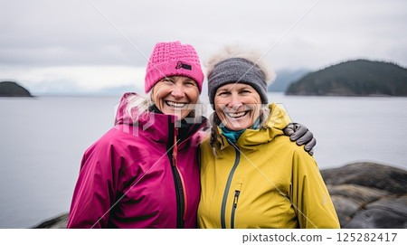 Middle aged women enjoying hiking. They radiate happiness and inspire others to pursue their passions, regardless of age. Middle aged women enjoying hiking. They radiate happiness and inspire others to pursue their passions, regardless of age. 125282417