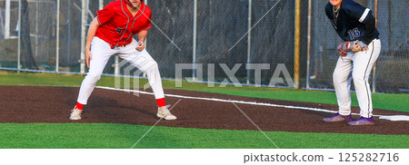 High School Baseball Player Leading off of First Base During a Game 125282716