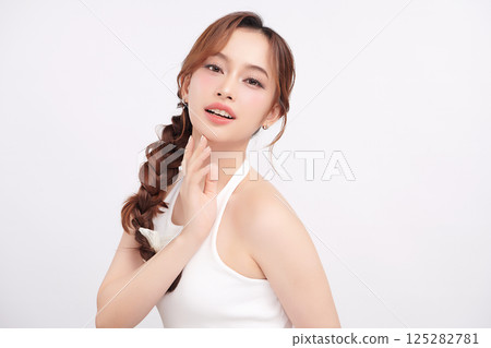 A beautiful young Asian woman with clean, fresh skin against a white background. Skincare, facial treatment, cosmetology, beauty, and spa. An elegant portrait of an Asian woman. A beautiful young Asian woman with clean, fresh skin against a white background. Skincare, facial treatment, cosmetology, beauty, and spa. An elegant portrait of an Asian woman. 125282781