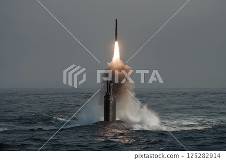 Nuclear war. Launch of a nuclear ballistic intercontinental missile from submarine. The submarine releases its deadly nuclear missile, breaking through waves with apocalyptic power. 125282914