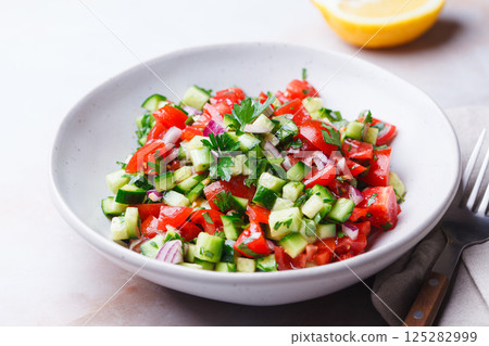 Vegetable salad with tomatoes, cucumbers, onions and parsley. Vegetable salad with tomatoes, cucumbers, onions and parsley. 125282999