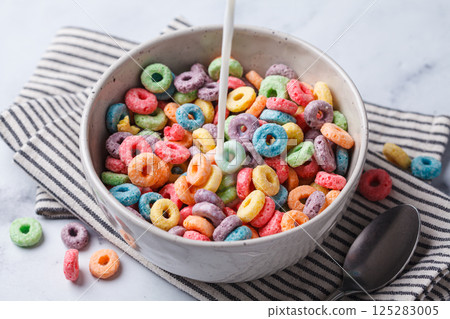 Colorful fruit cereal in bowl on white marble background. 125283005