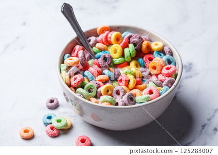 Colorful fruit cereal in bowl on white marble background. 125283007