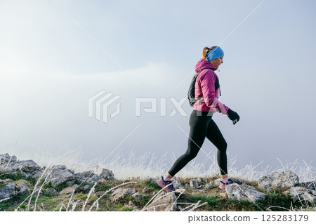 Trail Runner in Misty Mountain Landscape Trail Runner in Misty Mountain Landscape 125283179