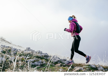 Trail Runner in Misty Mountain Landscape 125283437