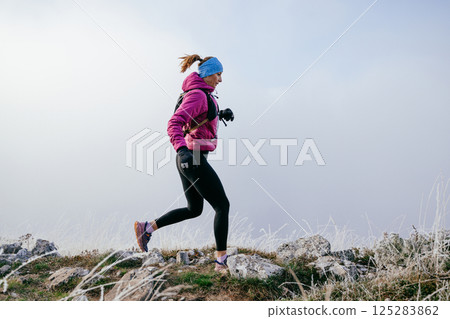 Trail Runner in Misty Mountain Landscape Trail Runner in Misty Mountain Landscape 125283862