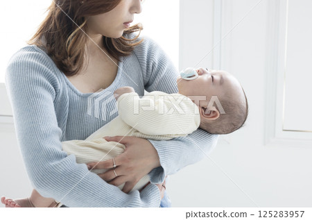 Cute mom holding a baby Cute mom holding a baby 125283957