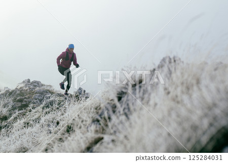 Trail Runner in Misty Mountain Landscape Trail Runner in Misty Mountain Landscape 125284031