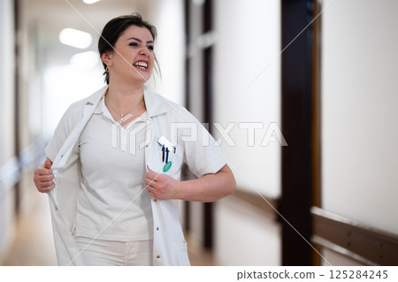 Medical personnel, including doctors and nurses, urgently respond in a busy hospital hallway, showcasing their quick action and teamwork in a critical situation Medical personnel, including doctors and nurses, urgently respond in a busy hospital hallway, showcasing their quick action and teamwork in a critical situation 125284245