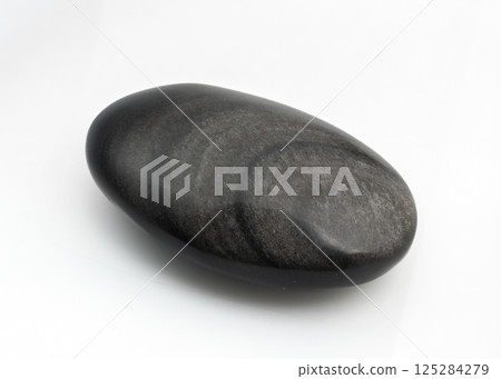 Polished black snow obsidian stone isolated on white background, smooth texture and unique pattern Polished black snow obsidian stone isolated on white background, smooth texture and unique pattern 125284279