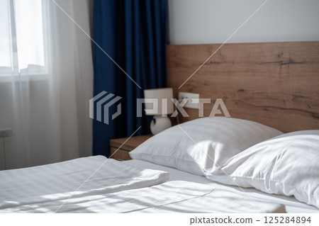 A modern and serene hotel room in a medical rehabilitation facility, designed for comfort and relaxation, offering a peaceful environment for patients to recover and rejuvenate 125284894