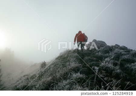 Trail running couple man and woman running on a mountain path 125284919