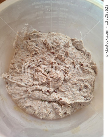 freshly mixed sourdough dough with starter ready for fermentation in a plastic bowl freshly mixed sourdough dough with starter ready for fermentation in a plastic bowl 125285622